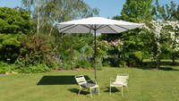 A straight parasol in a flower-filled garden