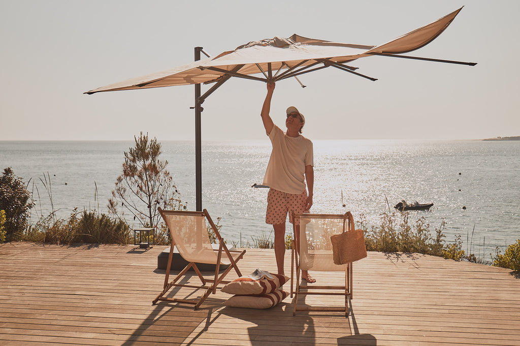 A man replacing the canopy of his parasol