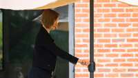 A woman adjusting her parasol