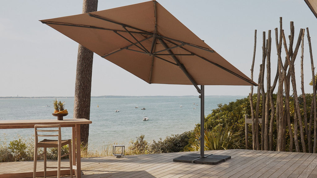 A large square cantilever umbrella on a terrace.