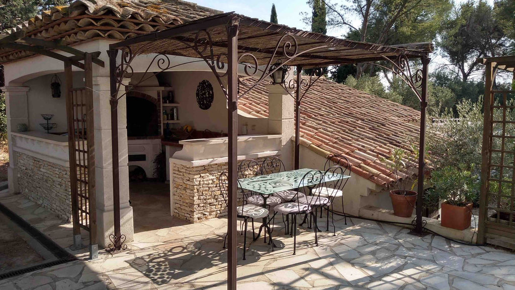 A wrought iron pergola on a terrace