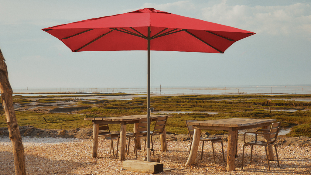 A straight parasol with a red polyester canopy