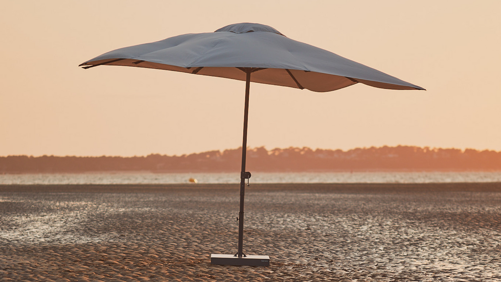 A center pole parasol on sand